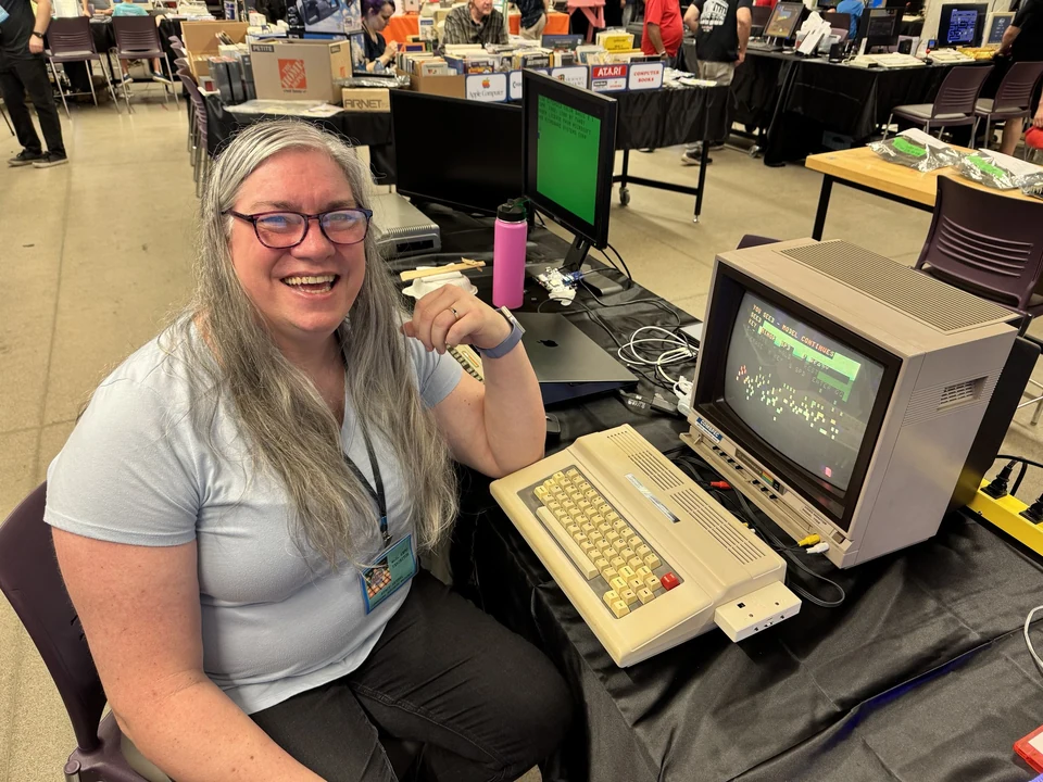 Stacey Vetzal beside a Tandy Colour Computer and CRT display at WoRC Expo 2026