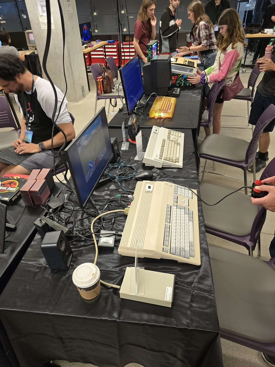 Amiga computers and visitors along the demonstration table at WoRC Expo 2026
