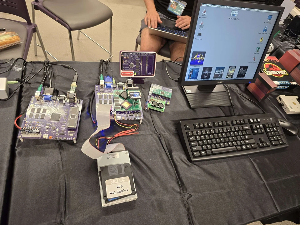 AmiCube and Minimig hardware with a floppy drive and Workbench display at WoRC Expo 2026