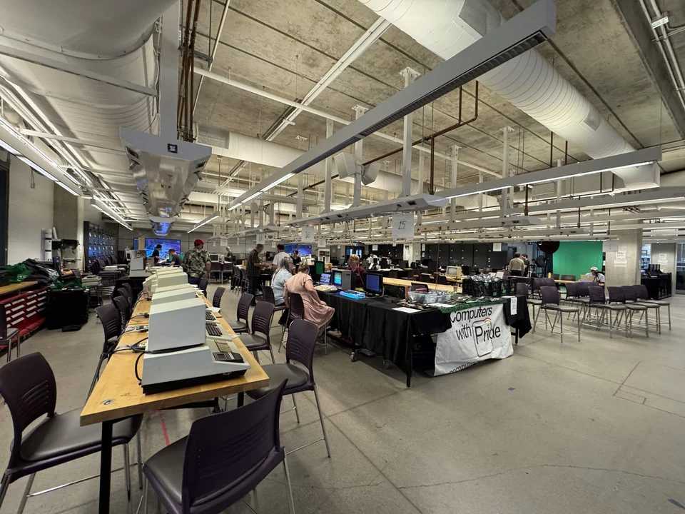 Rows of vintage computer displays beneath the exposed ceiling of the WoRC Expo 2026 venue