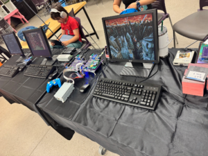 Minimig exhibit at WoRC Expo 2026 with Amiga hardware, monitors, keyboards and a floppy drive.