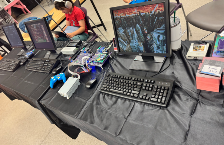 Minimig exhibit at WoRC Expo 2026 with Amiga hardware, monitors, keyboards and a floppy drive.